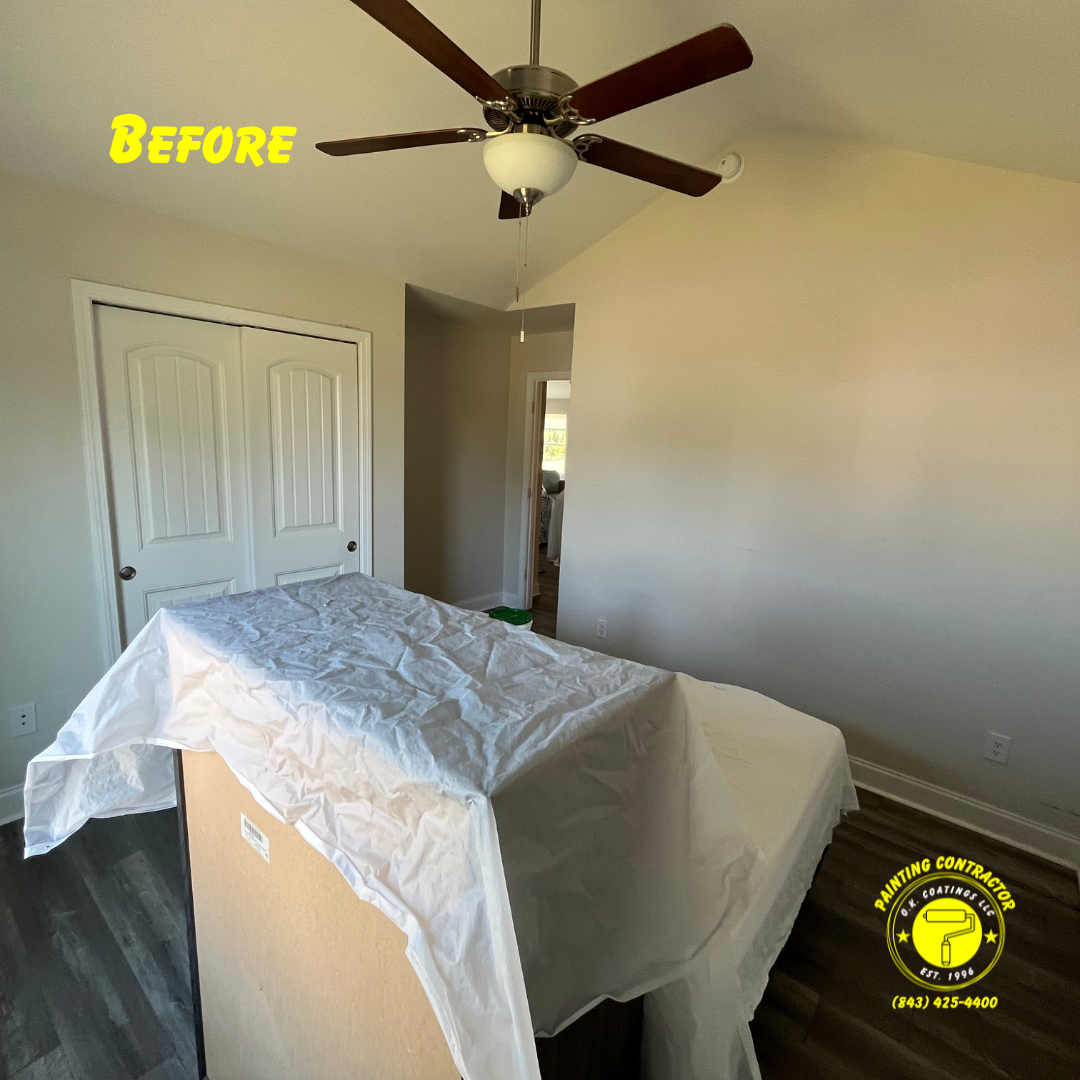A bedroom interior with beige walls, wood-look flooring, and a ceiling fan, prepared for painting with a covered item.