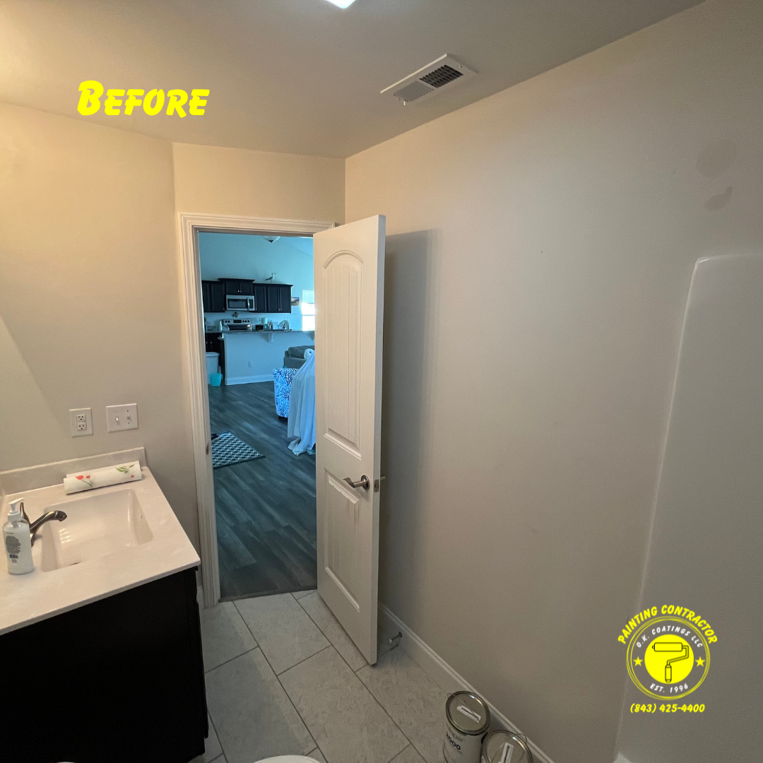 A view of a bathroom vanity and an open doorway looking into a kitchen before a renovation.