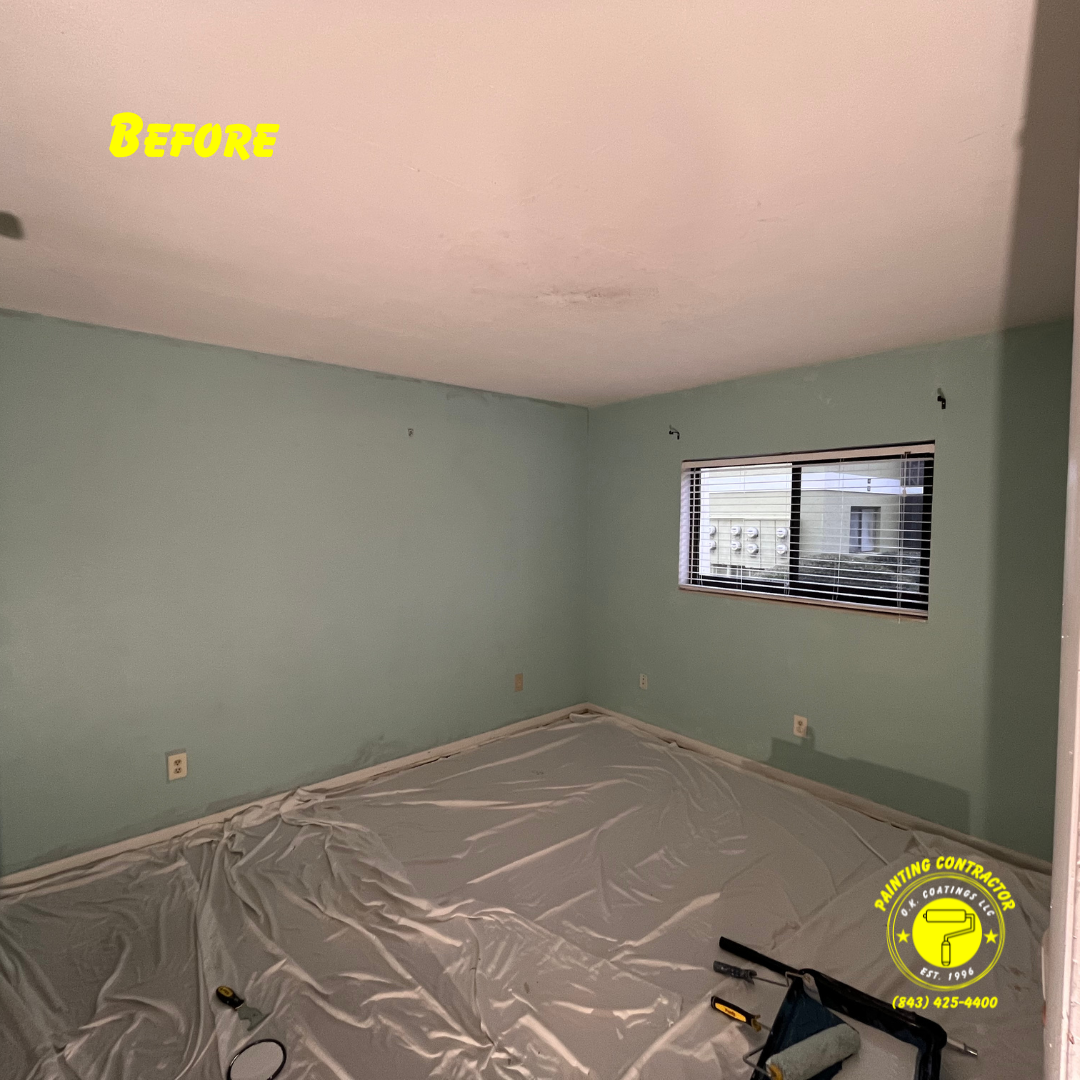 An empty room with light green walls, a white ceiling, and plastic drop cloths on the floor, marked as a 