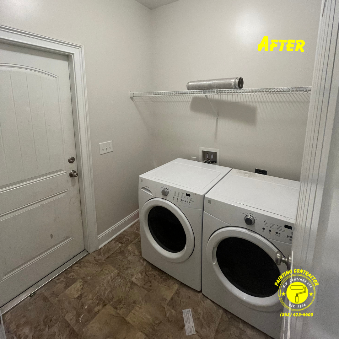 A white washer and dryer in a small laundry room with light gray walls, a white door, and a wire shelf above.
