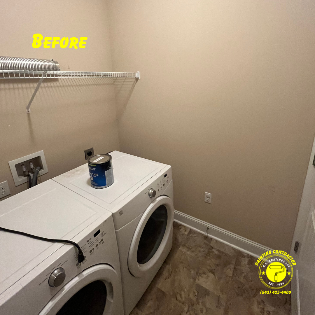 A beige-walled laundry room featuring a white washer and dryer with a paint can on top and a wire shelf above.