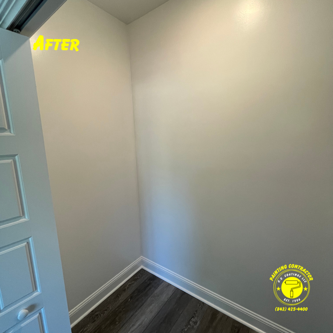Newly painted, light-colored walls meet wood-look flooring inside a closet, with a branding logo in the corner.
