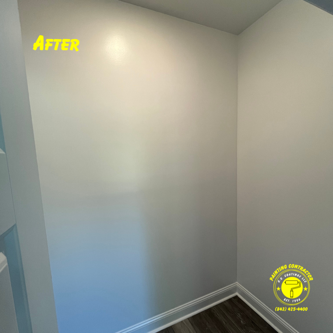 An interior corner with smooth, light gray painted walls, white trim, and wood-look flooring, labeled 