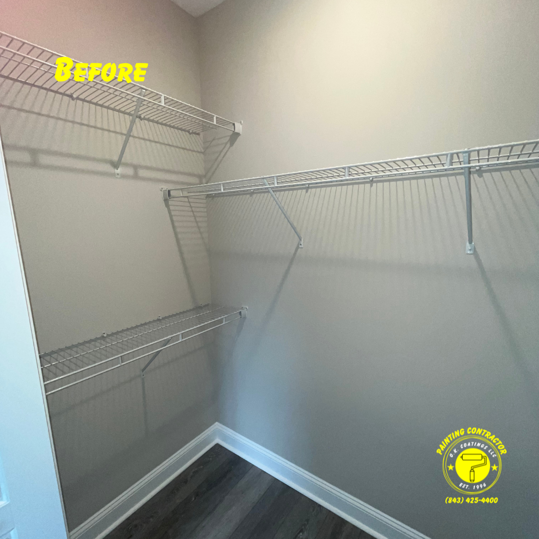 An empty reach-in closet with beige walls, dark wood-look flooring, and white wire shelving.
