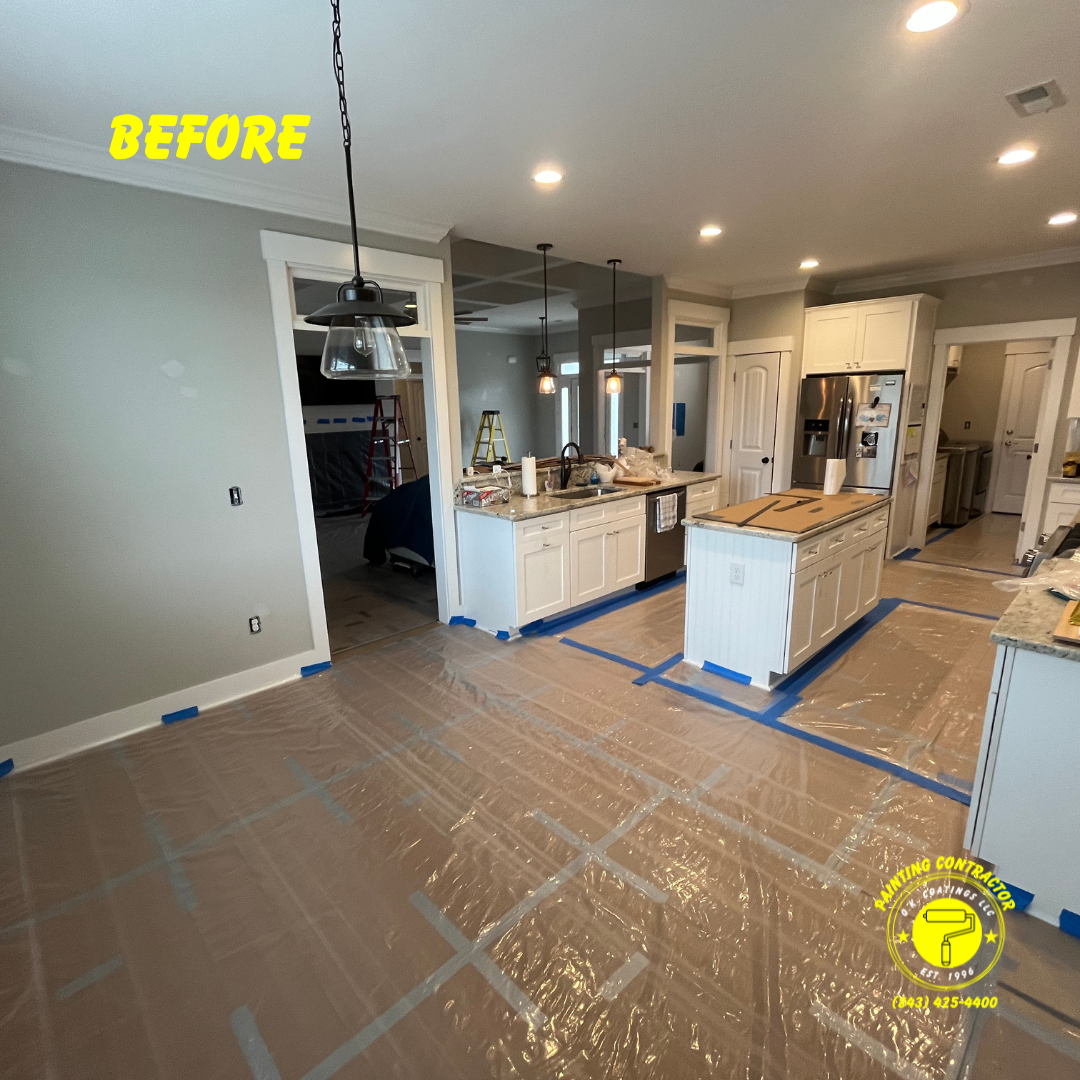 A kitchen under renovation with protective plastic flooring, taped edges, and white cabinets before a paint job.