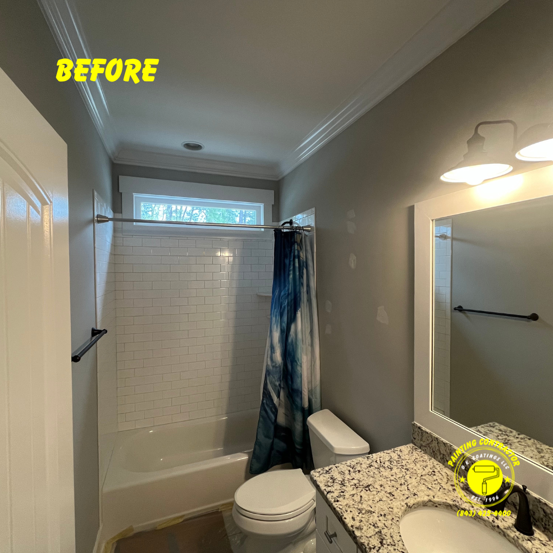 A bathroom featuring grey walls, a white tiled tub shower, a granite countertop vanity, and a blue shower curtain.