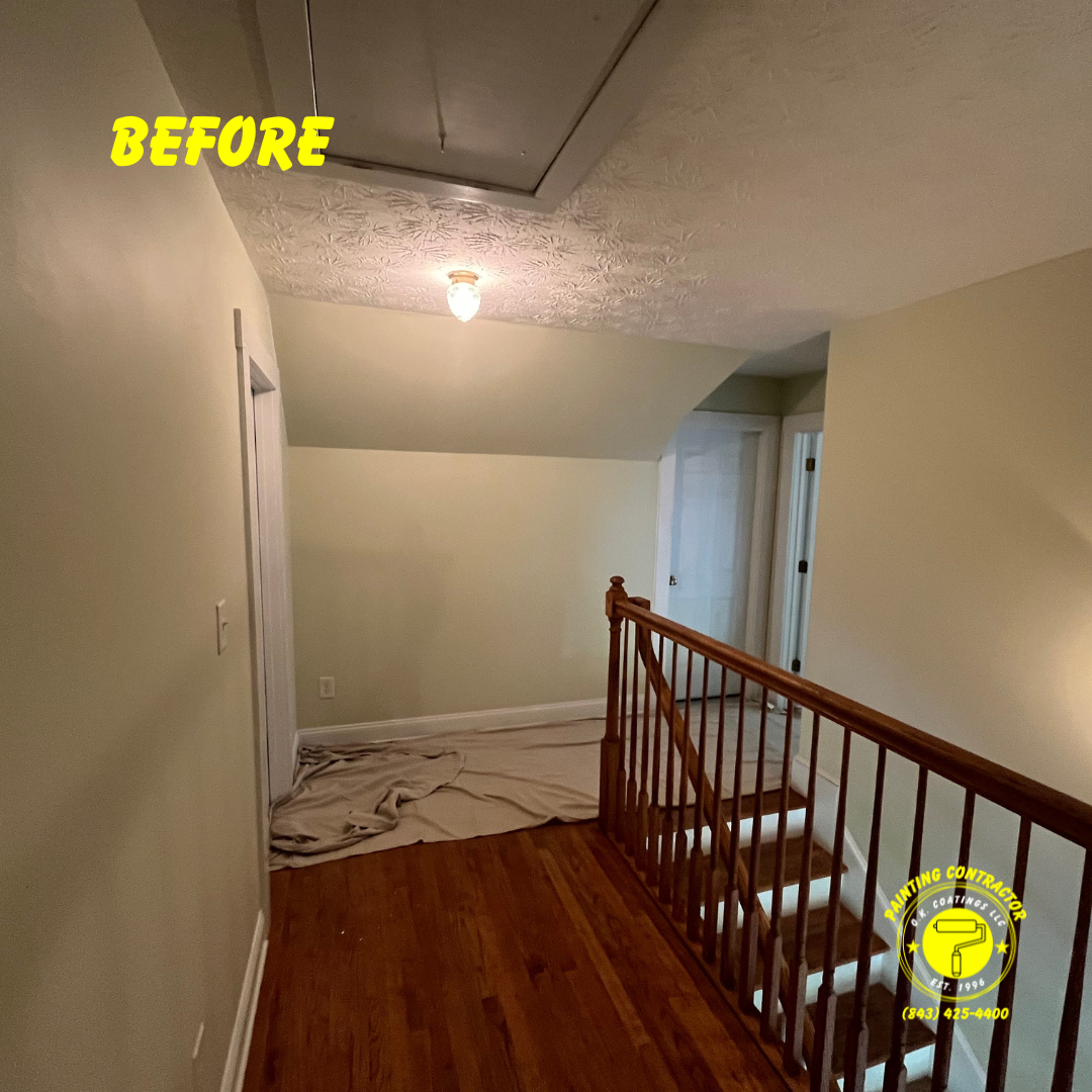 A before view of a hallway featuring a wooden staircase, light-colored walls, and a drop cloth on the floor.