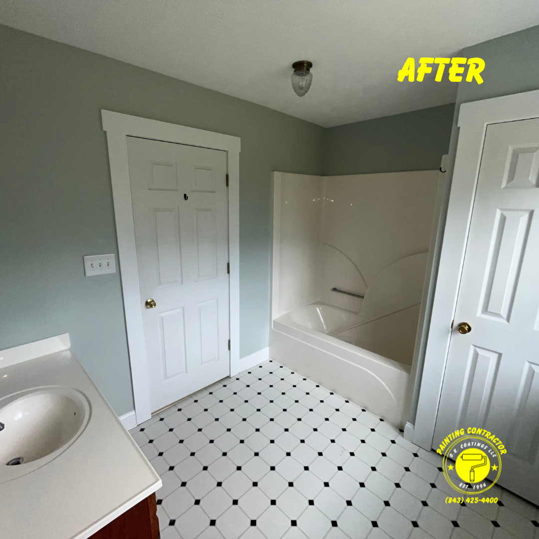 A remodeled bathroom with grey walls, white trim, a white bathtub, and black and white checkered tile flooring.