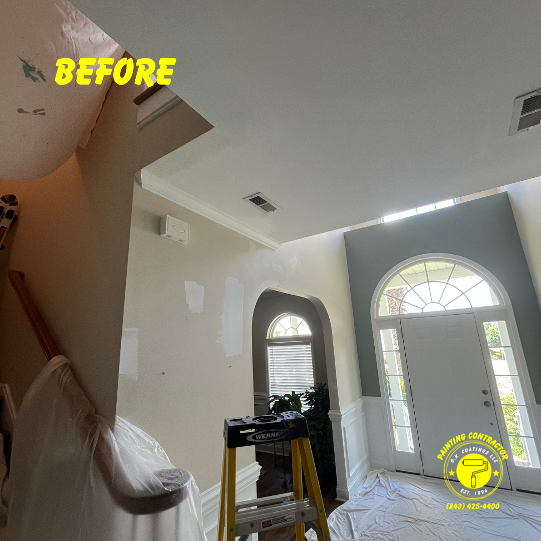 A foyer entryway during interior renovation, showing walls with patches of white primer and a yellow 