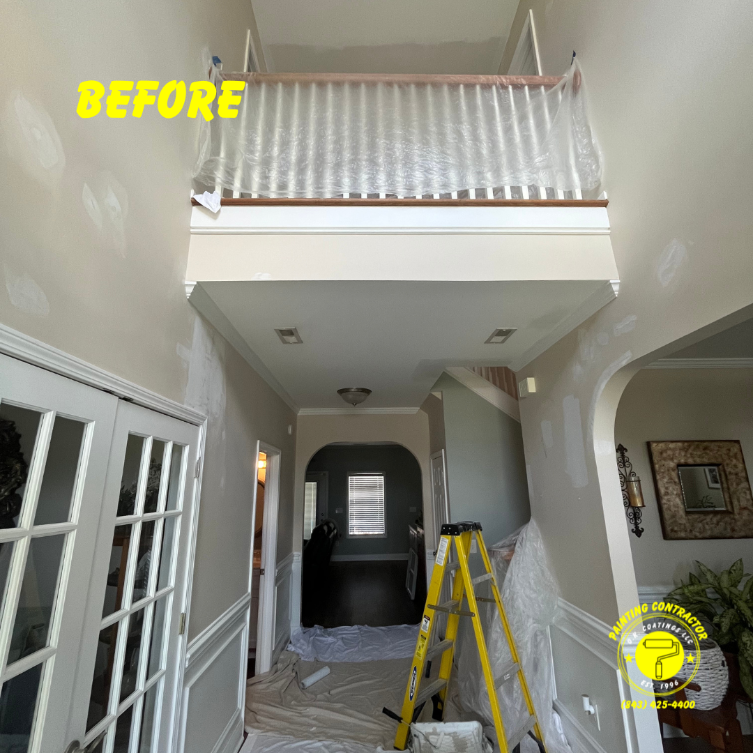 A high-ceilinged home interior under renovation, with walls patched in preparation for painting and protective plastic.