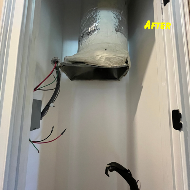 An open closet showing a silver duct suspended above, with electrical wiring and a black pipe visible below.