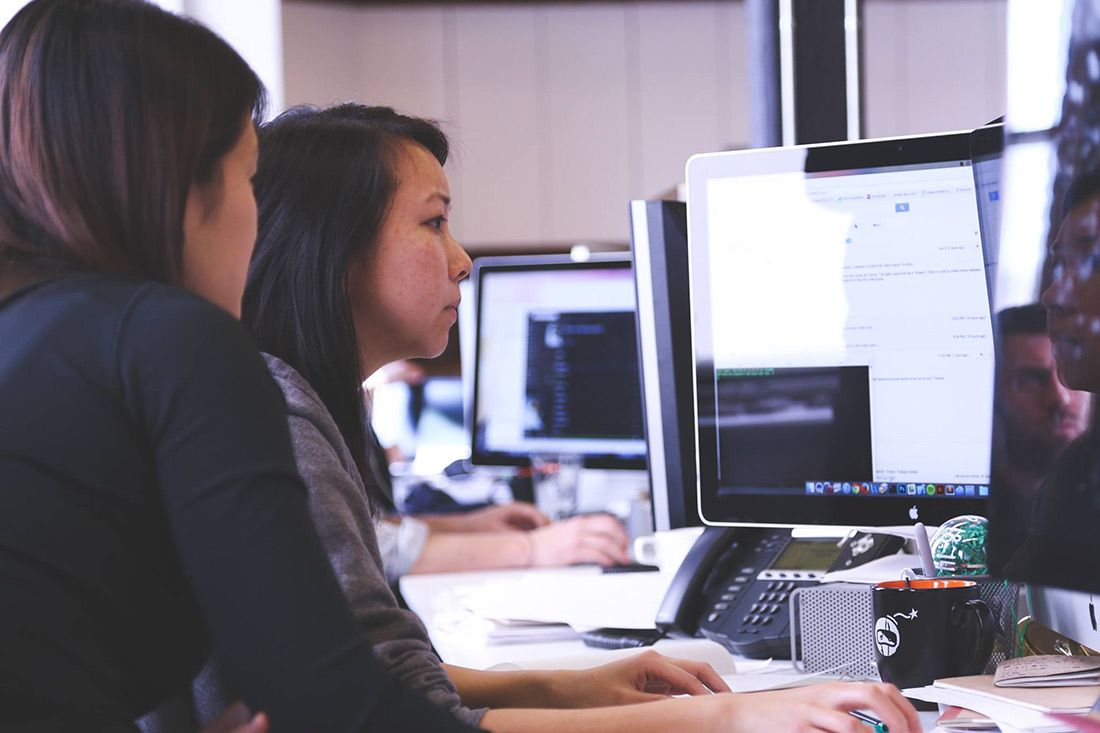 A Group of People Are Sitting at Desks in Front of Computer — Rochdale Accounting & Business Advisory in Alstonville, NSW