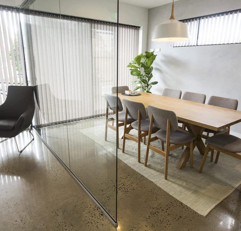 A Dining Room With a Table and Chairs Behind a Glass Wall — Rochdale Accounting & Business Advisory in Alstonville, NSW