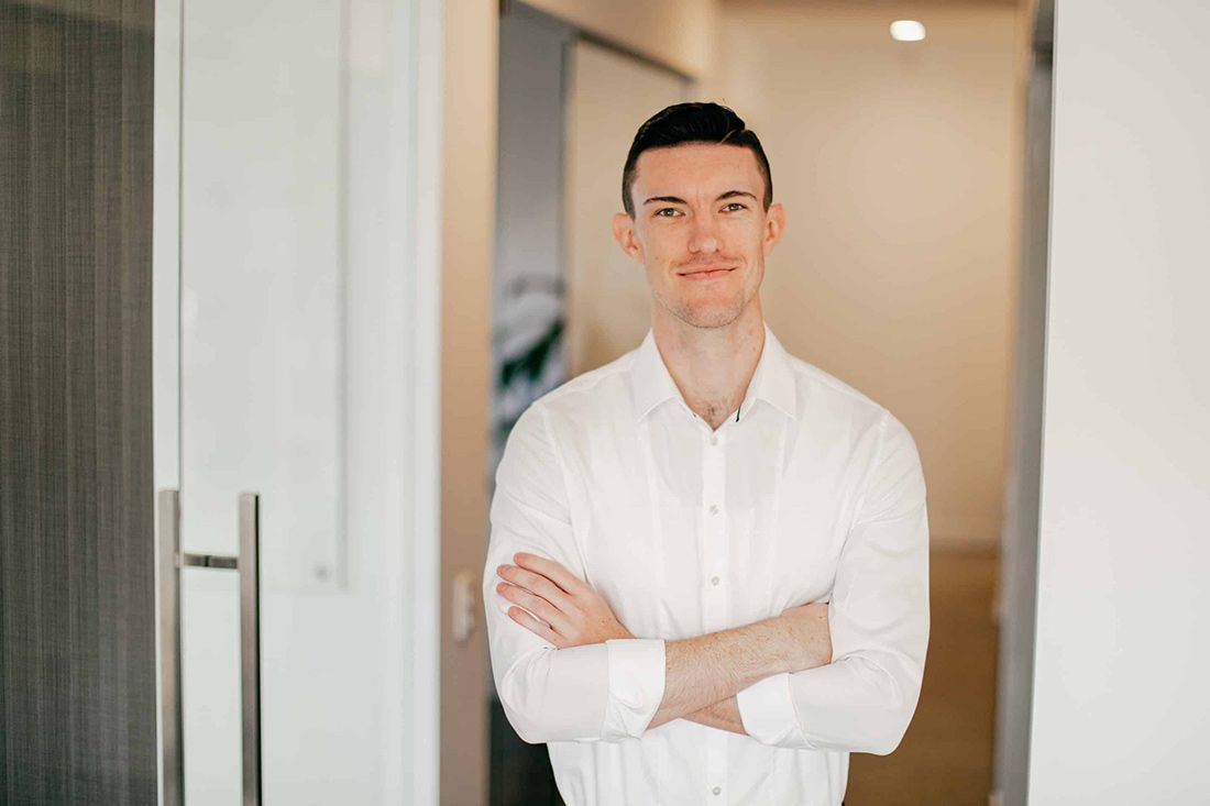 A Man in a White Shirt is Standing in a Hallway — Rochdale Accounting & Business Advisory in Bundaberg, QLD