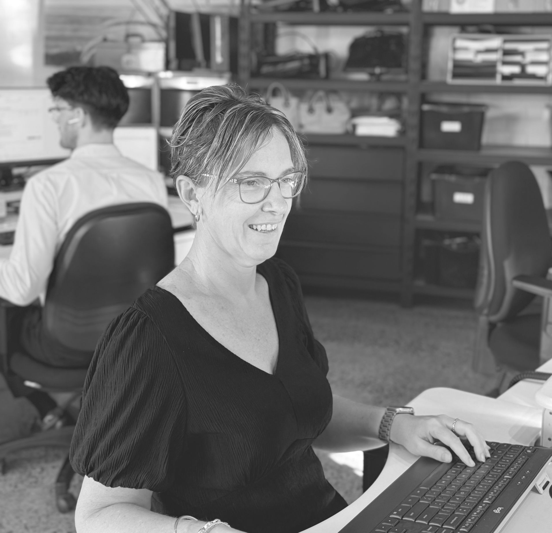 A Man in a Suit and Tie is Sitting at a Table With Two People — Rochdale Accounting & Business Advisory in Alstonville, NSW