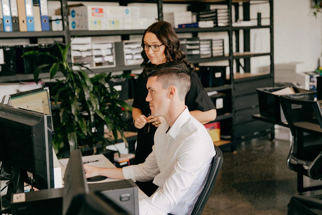 A Man and a Woman Are Sitting at a Desk in Front of a Computer — Rochdale Accounting & Business Advisory in Alstonville, NSW