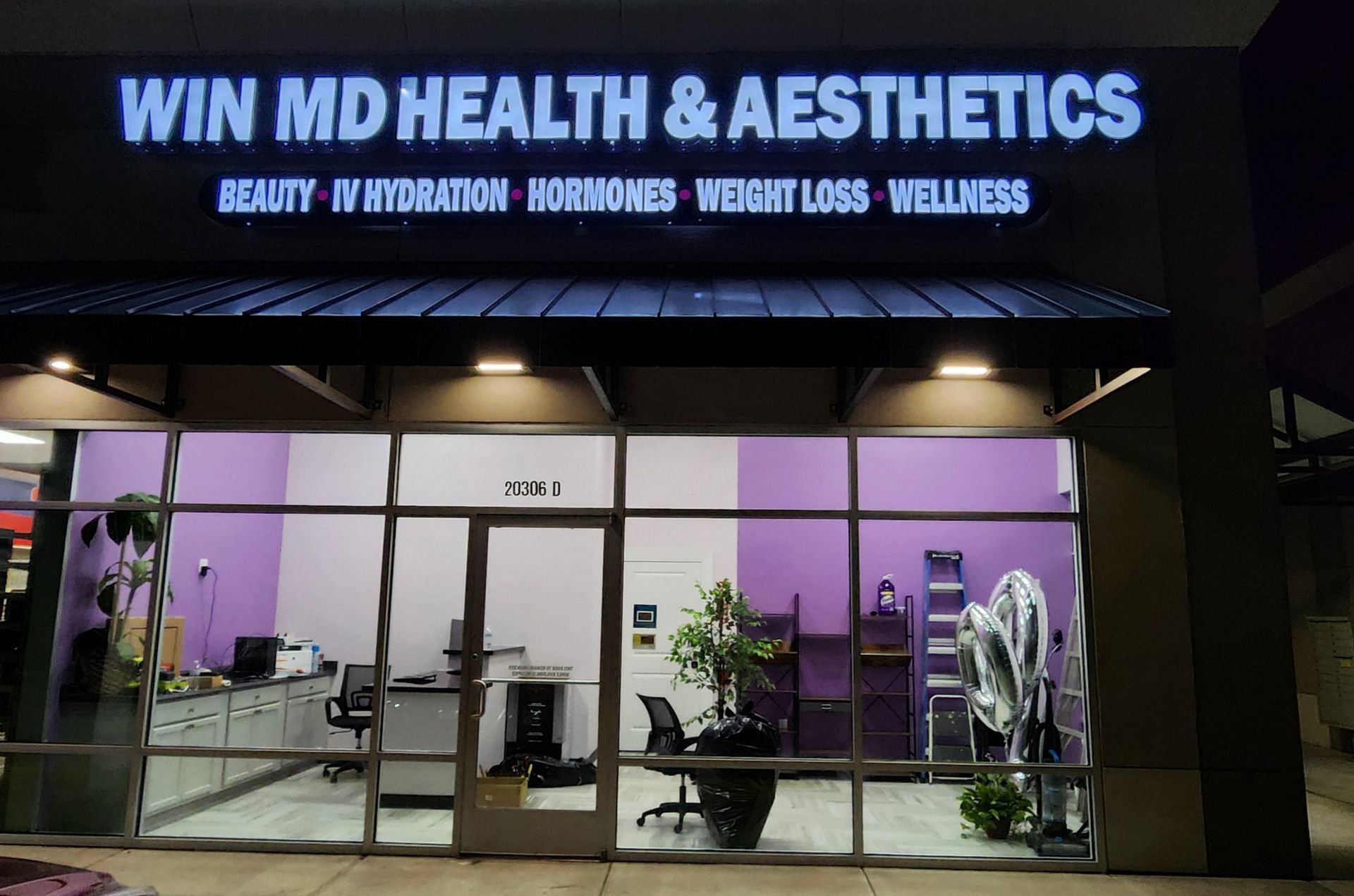 A store front with a sign that says win md health & aesthetics