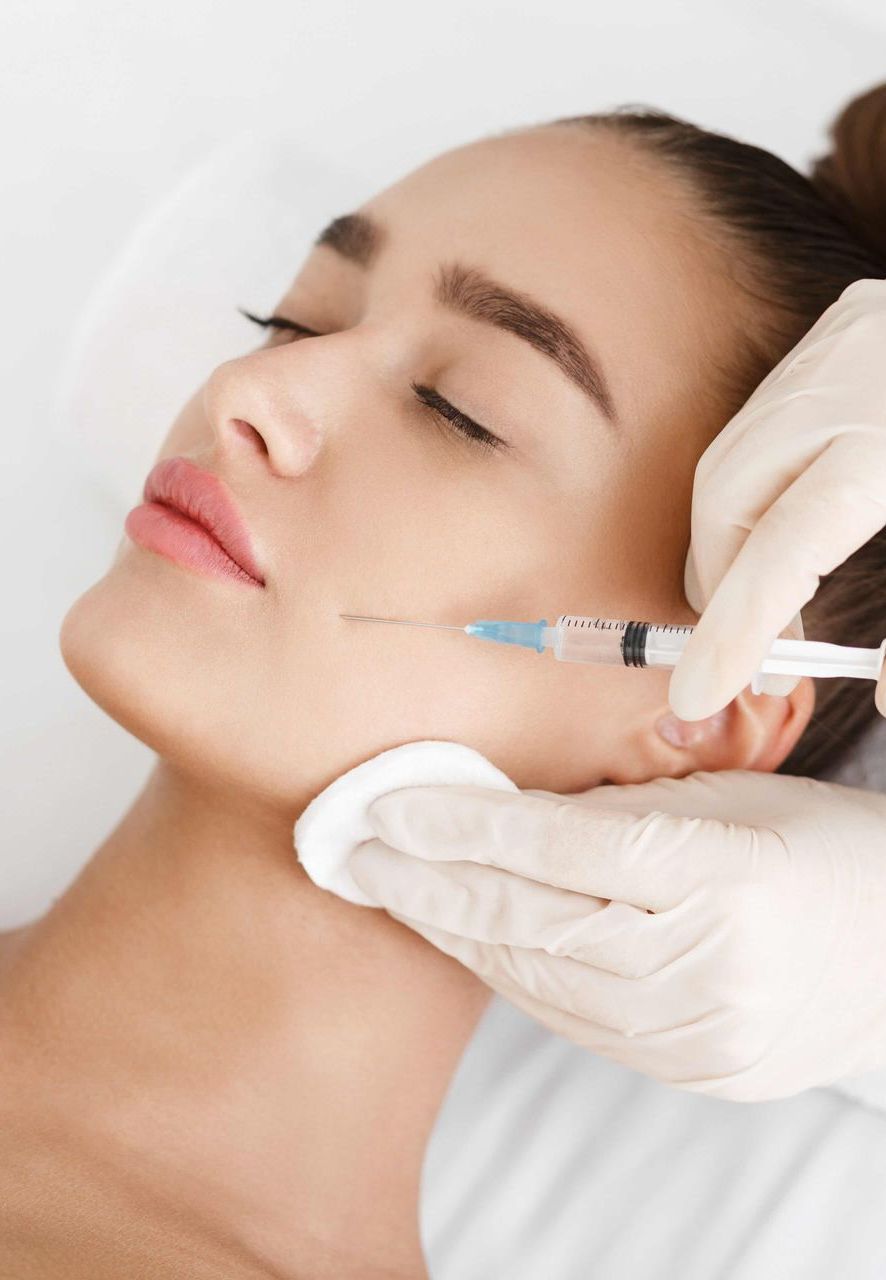 A woman is getting a botox injection in her face.