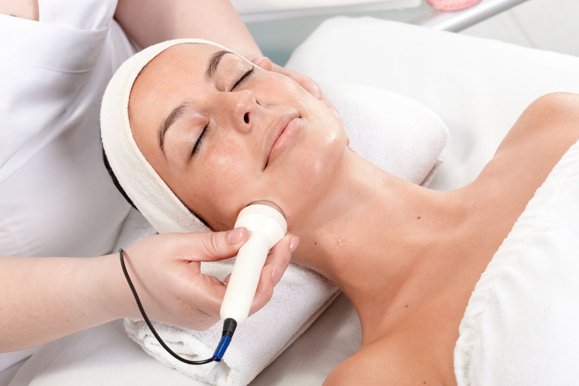 A woman is getting a facial treatment at a spa.