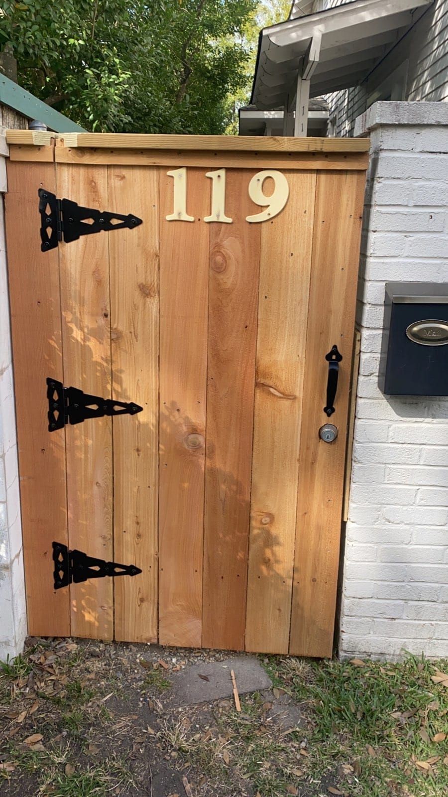 A wooden gate with the number 119 on it.