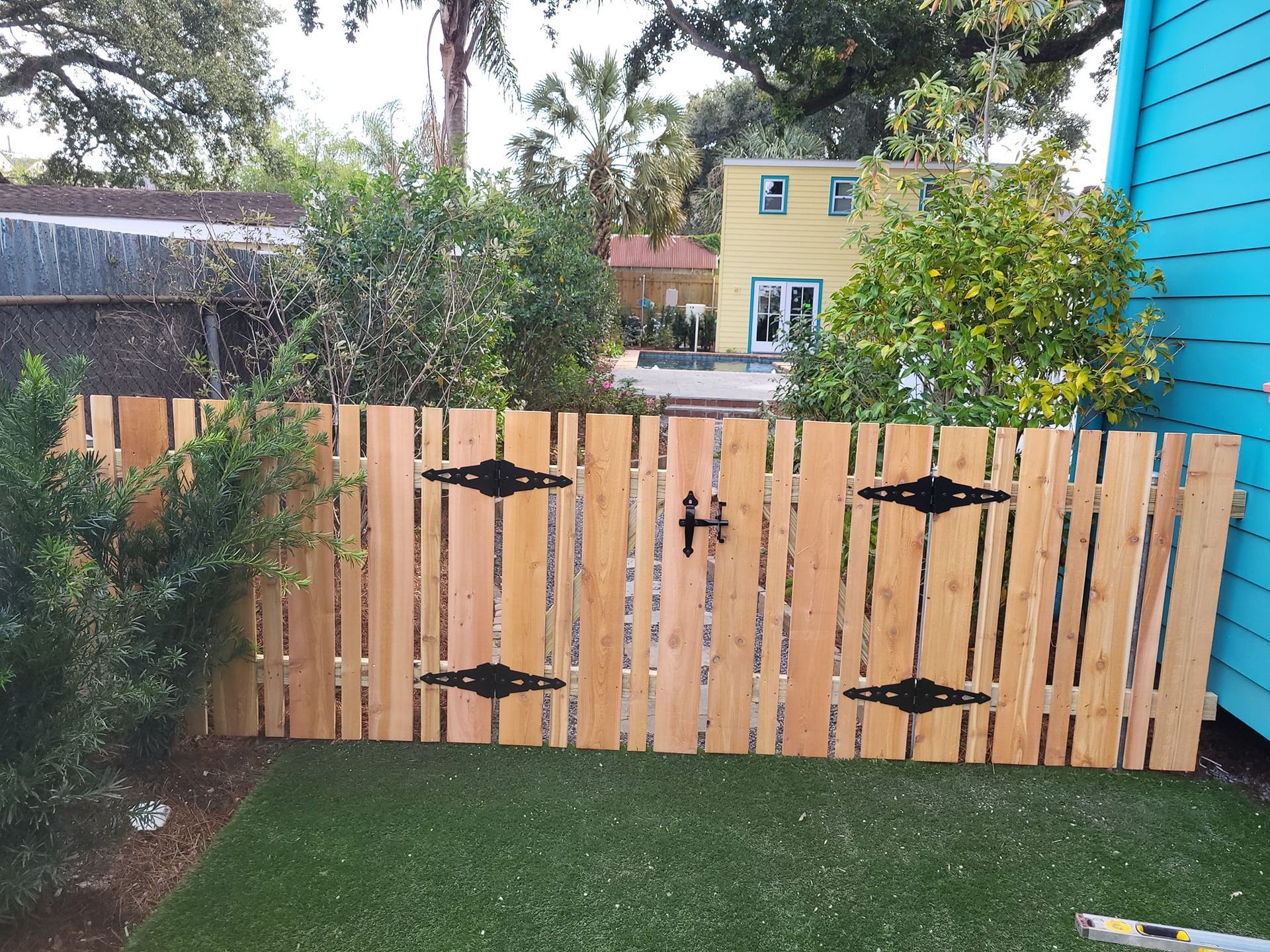 A wooden fence with a blue building in the background