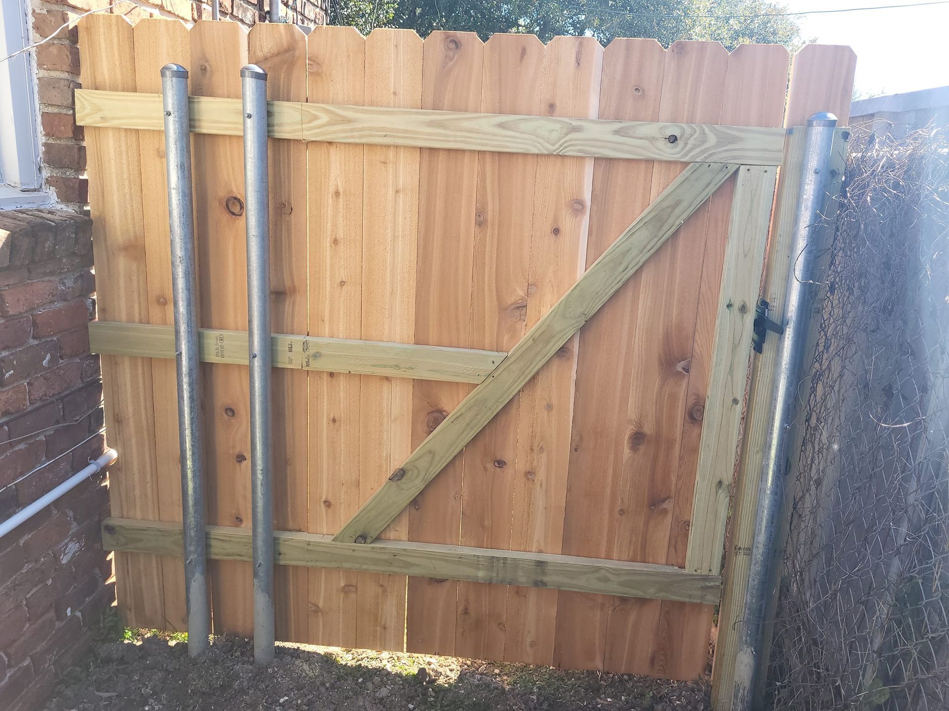 A wooden fence with a gate attached to it
