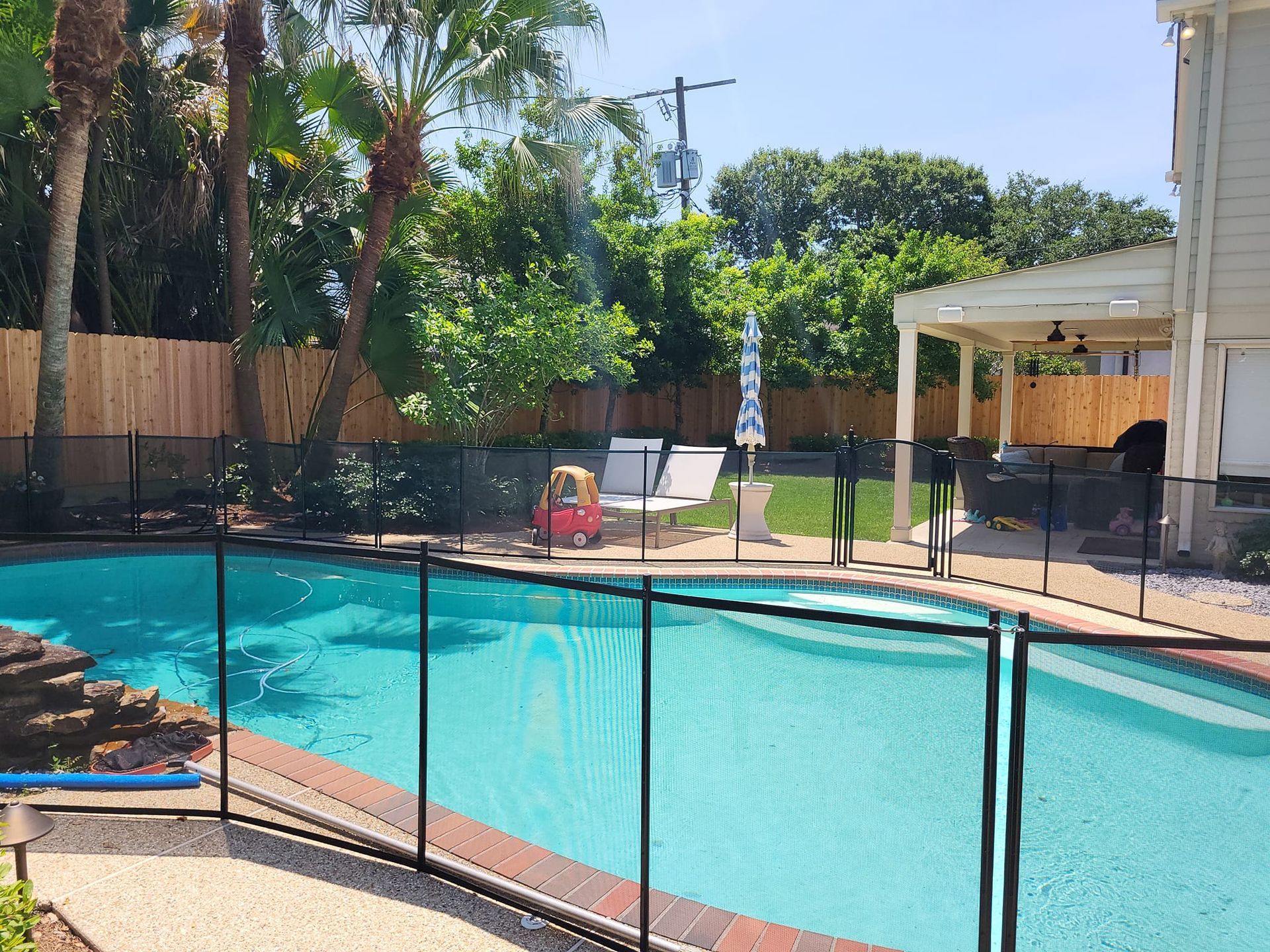 A large swimming pool with a fence around it