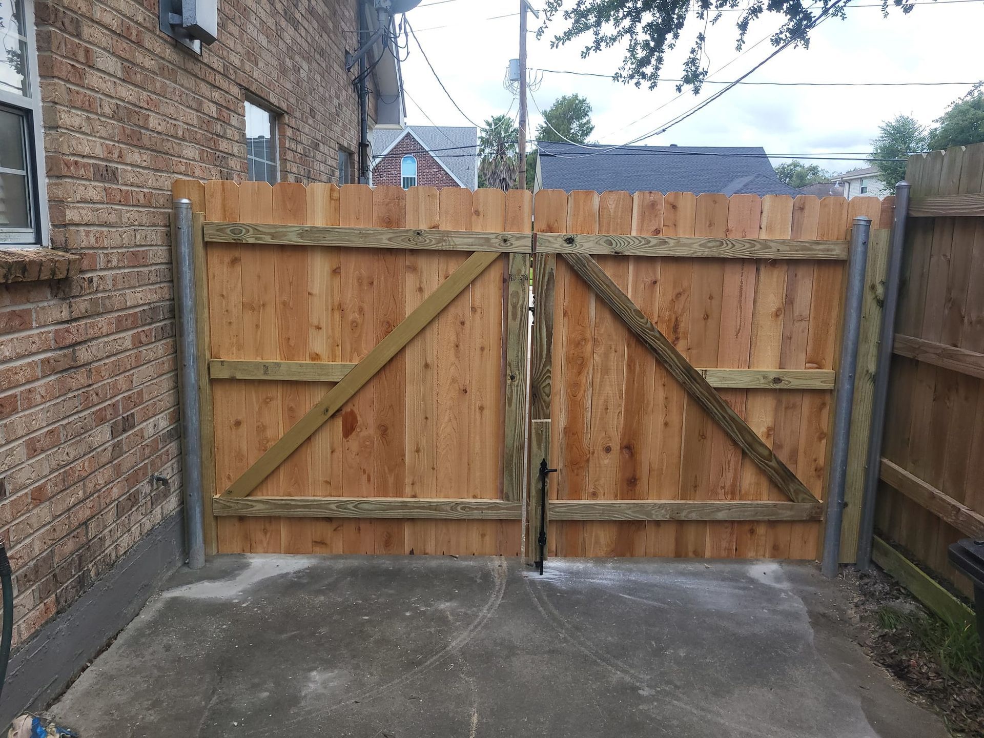 A wooden fence is in front of a brick building