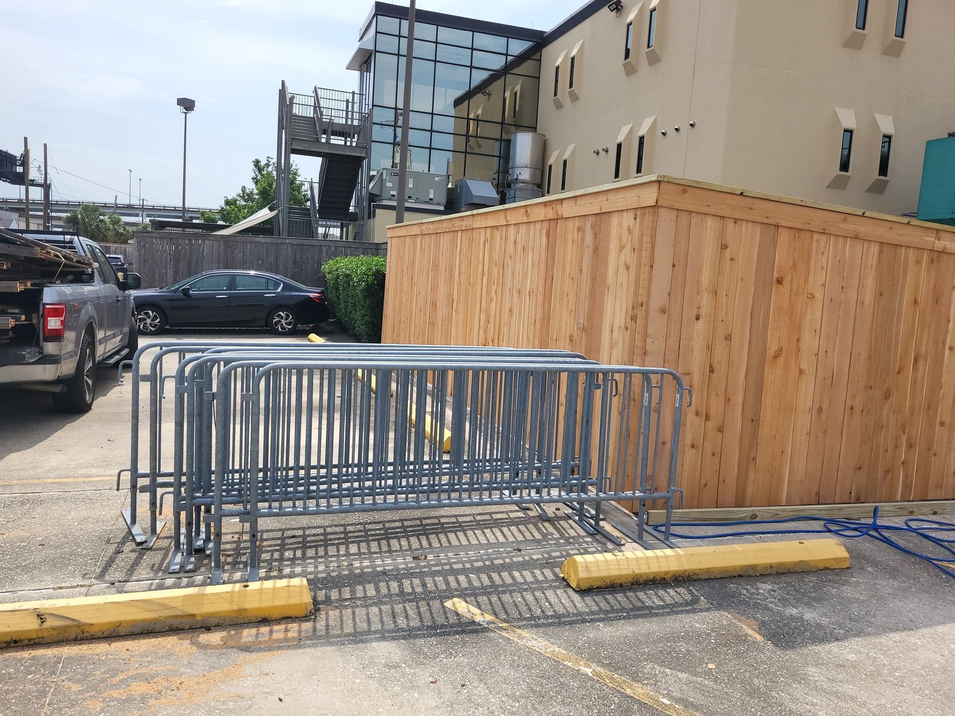 A truck is parked in front of a wooden fence.