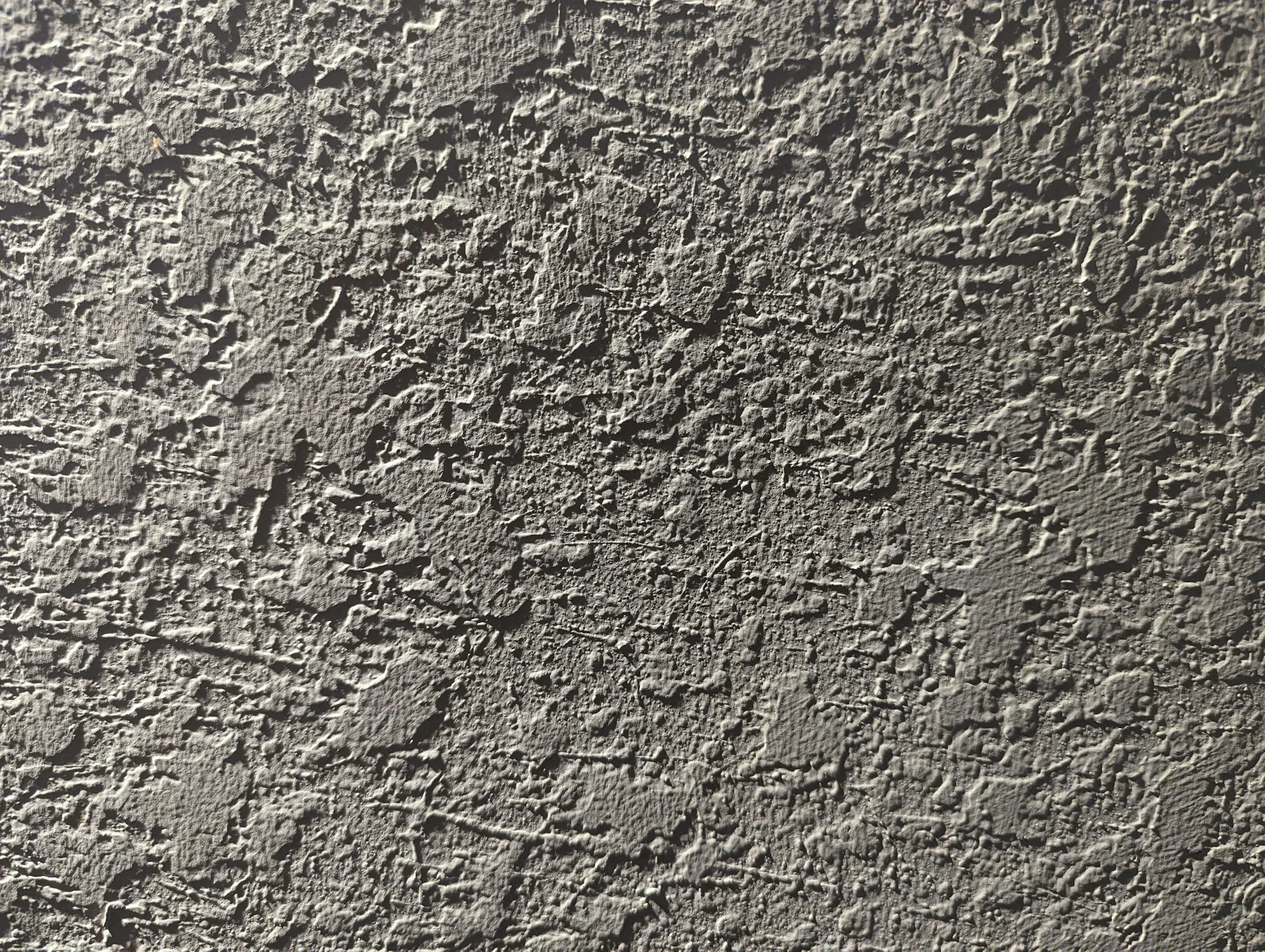 Close-up of rough gray stucco wall texture