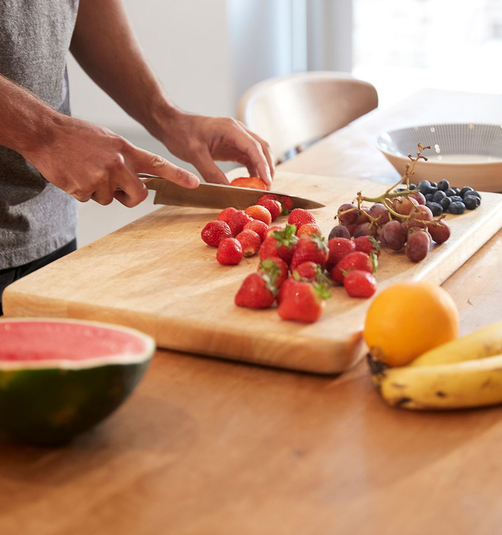 Person preparing fresh fruit, representing an everyday activity occupational therapy helps you return to life