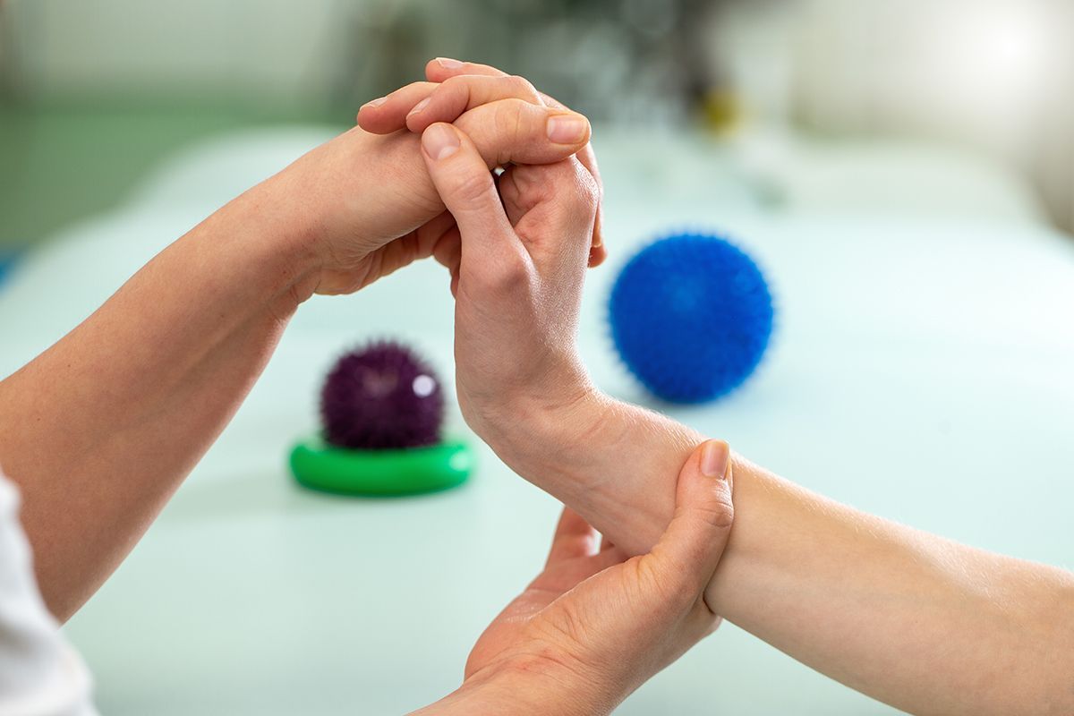 Checking movement during an OT evaluation Therapist checking a patient's hand and wrist movement during an occupational therapy evaluation