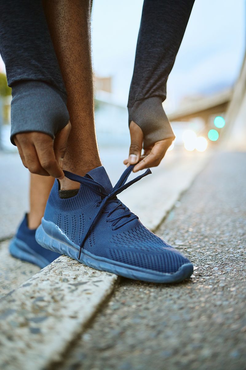 Person tying a shoelace, representing an everyday fine motor task supported by occupational therapy