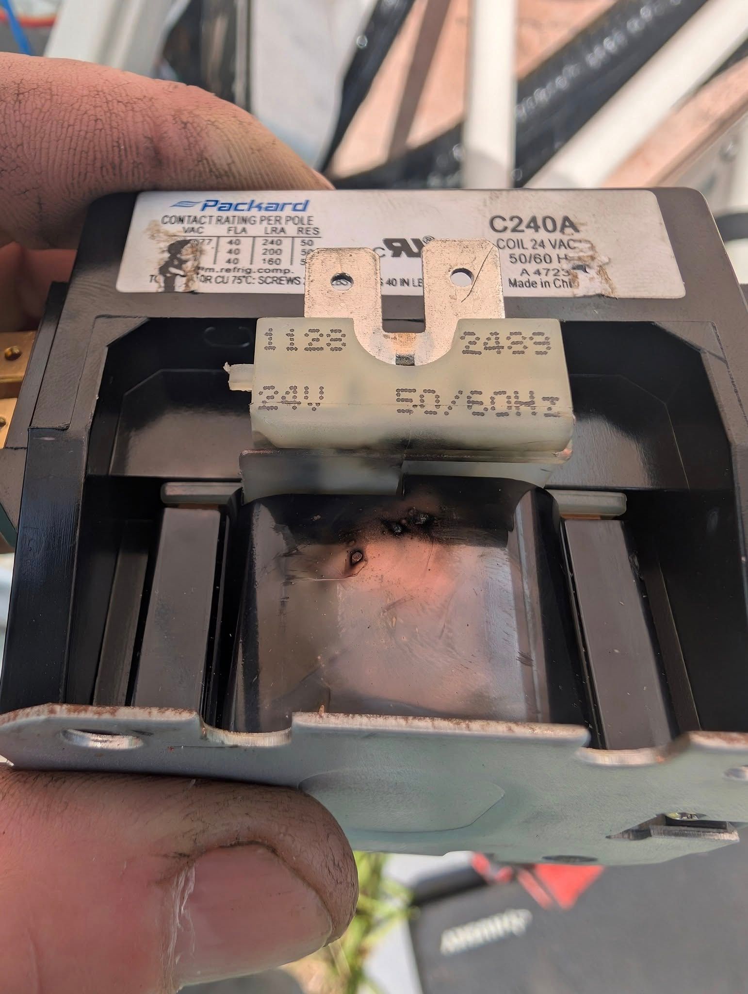 A close up of a person holding a relay in their hand.