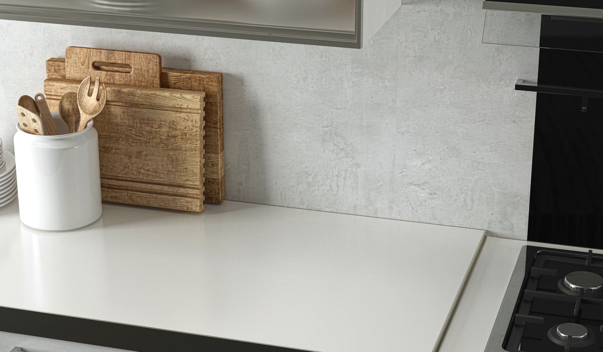 Kitchen counter with cutting boards, utensils, and stove top. White and neutral tones. Kitchens Countertops Louisville, KY