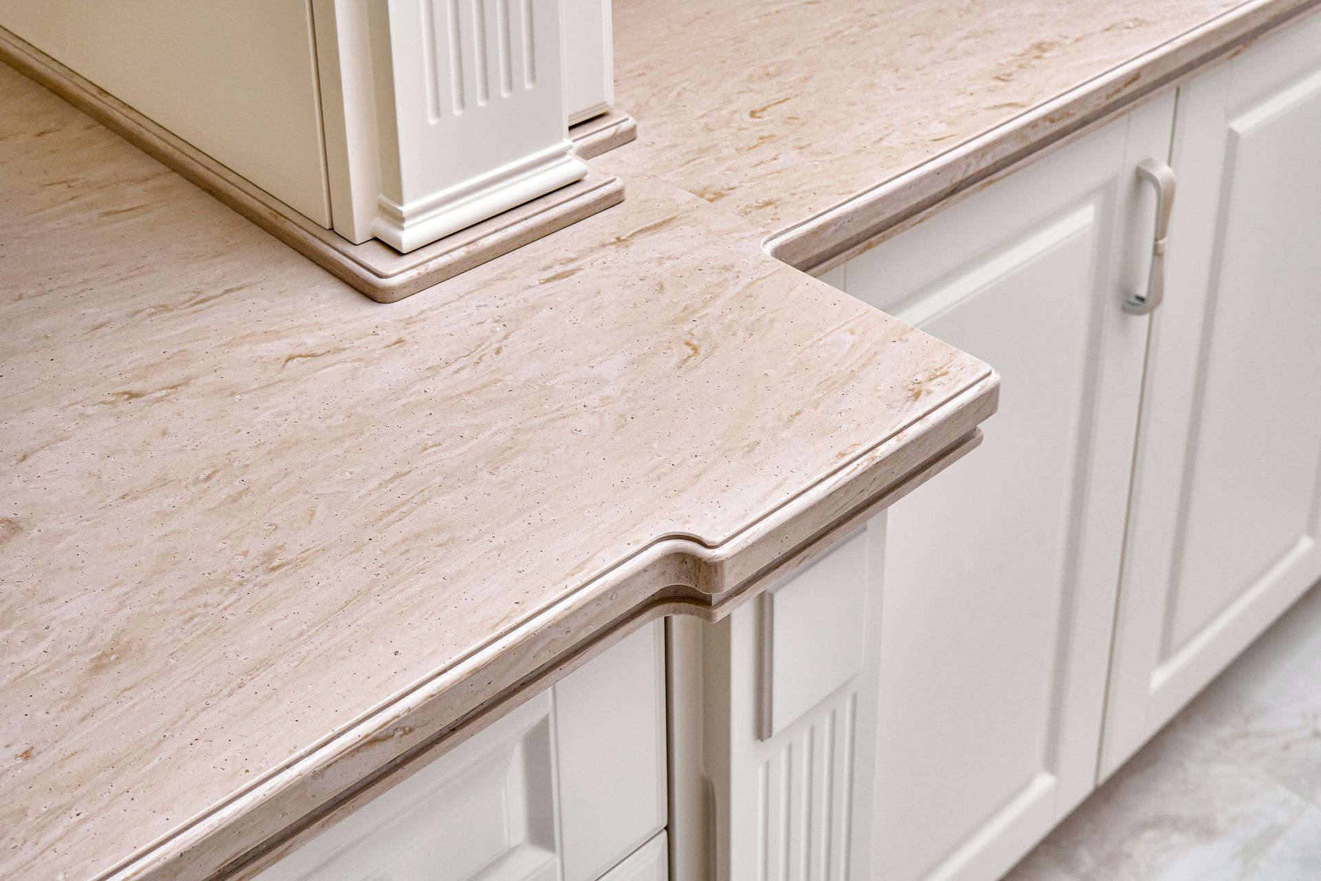 Beige countertop with decorative edge on white cabinets. Beige countertop with decorative edge on white cabinets.