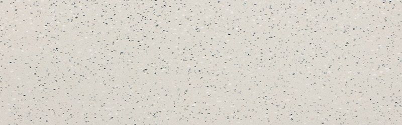 Off-white quartz countertop with tiny, dark flecks throughout.