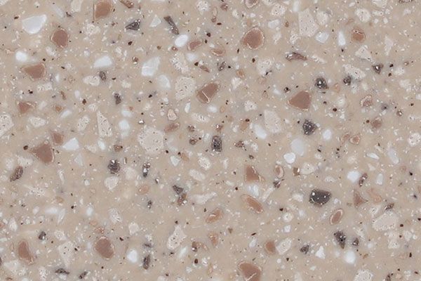Close-up of a speckled beige and light brown countertop with various sized flecks.
