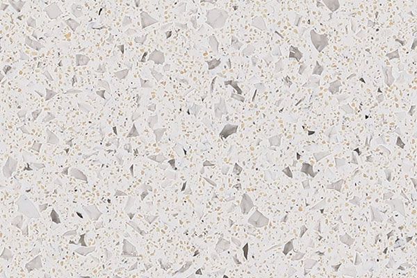 White countertop with speckled pattern and larger, irregularly shaped gray fragments.