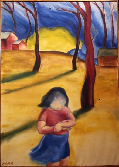 Blurred child in red shirt and blue skirt standing in a yellow field with tall dark trees and houses beyond