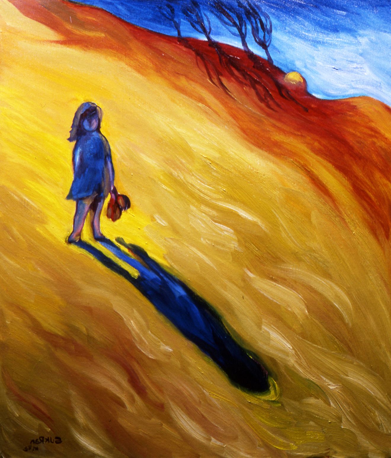 Lone figure in blue on a sunlit yellow hillside, casting a long shadow under a blue sky.