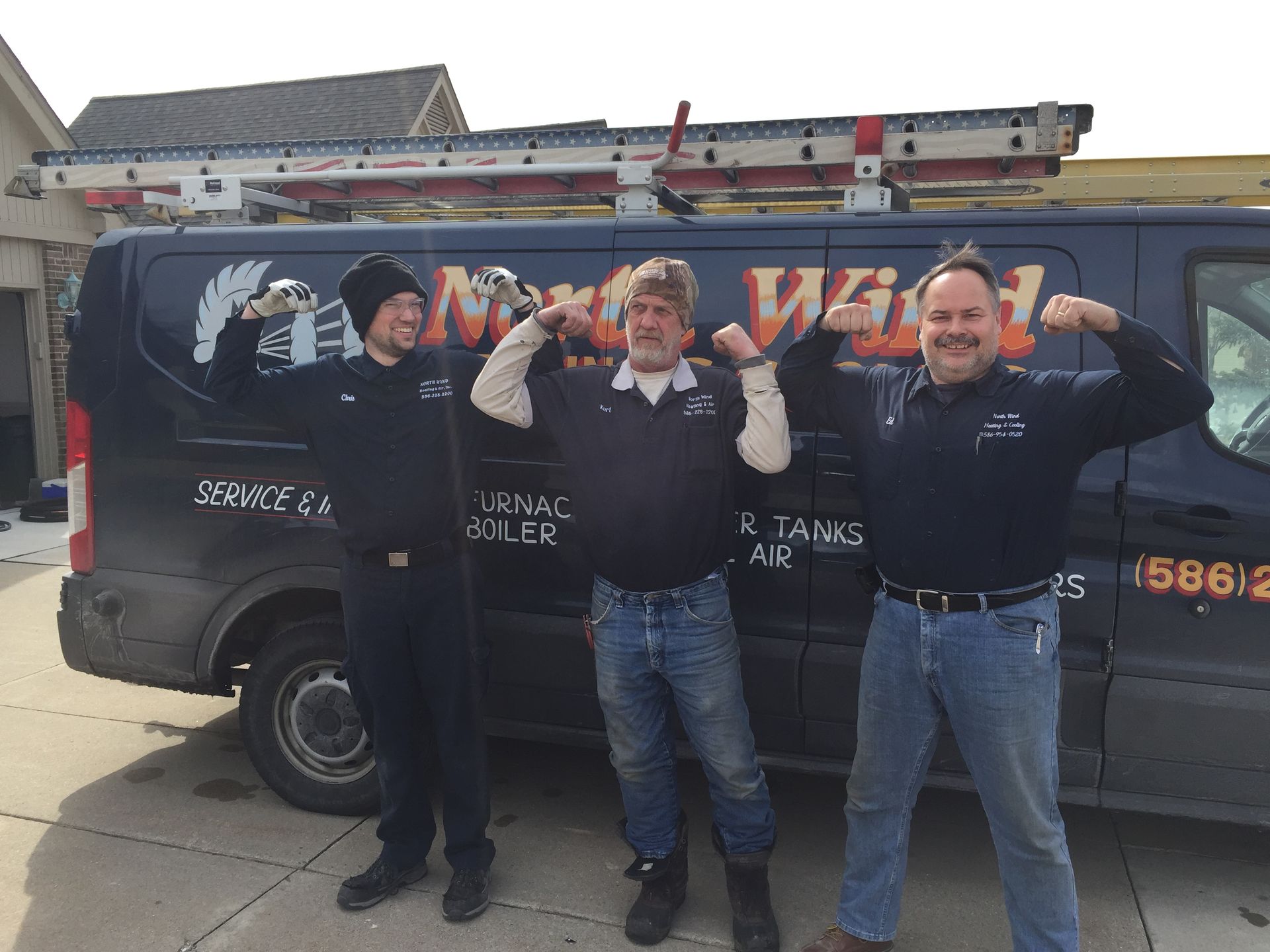 Three men flexing their biceps in front of a work van. The van has a company logo.