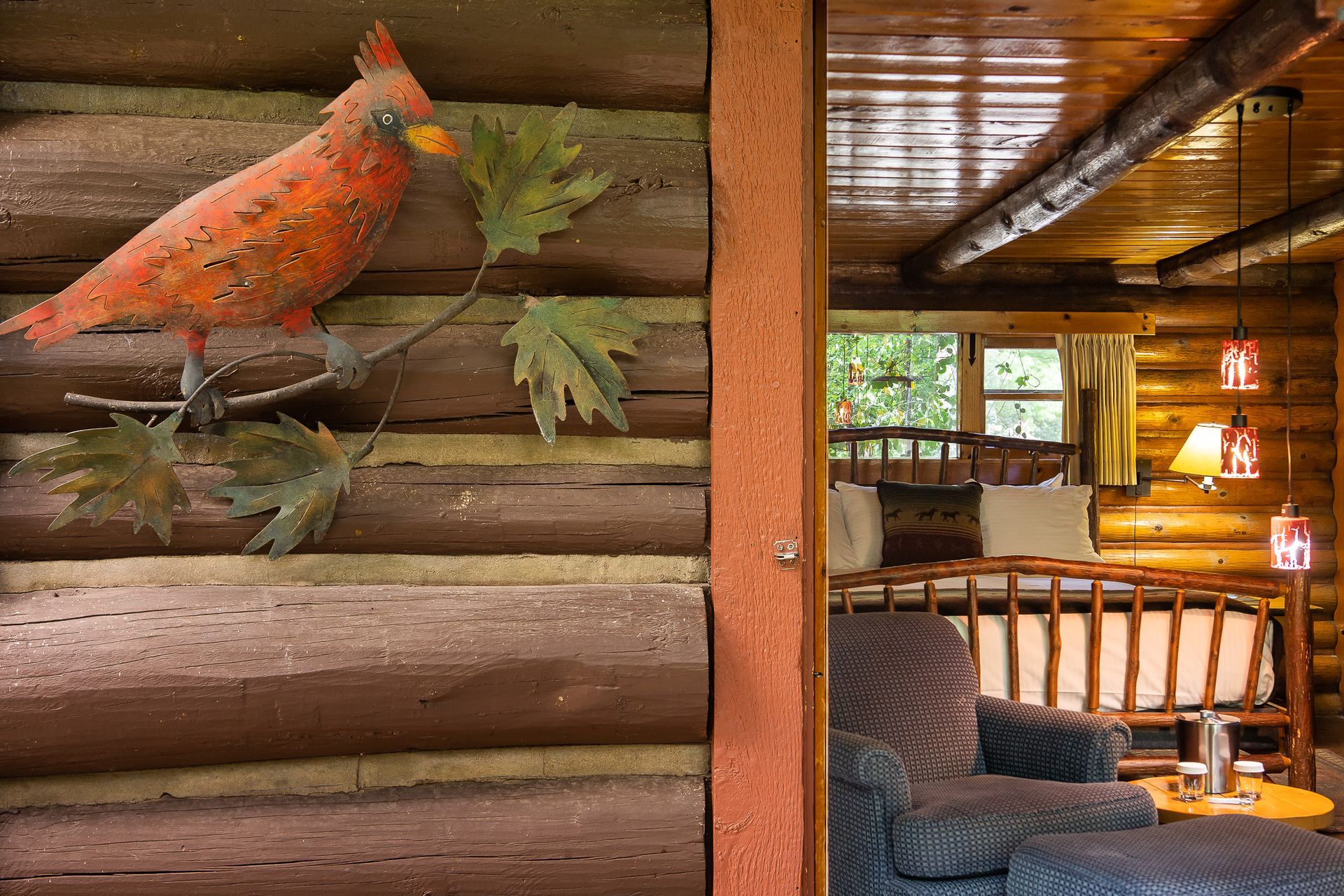 Orange bird on wooden wall in rustic cabin interior with cozy seating and warm lights