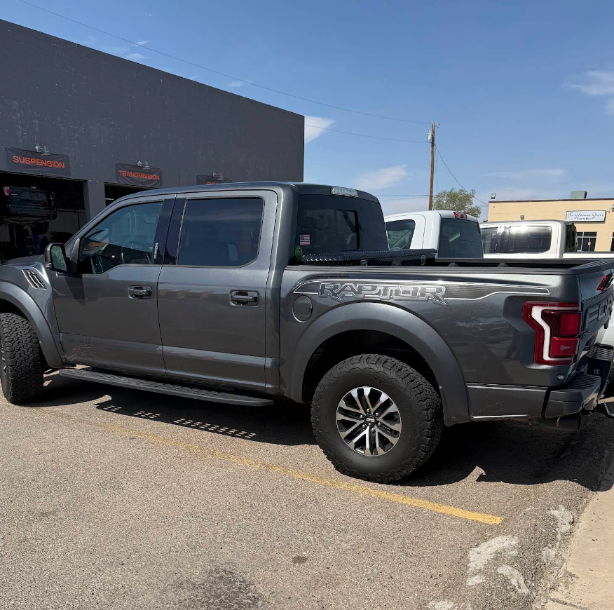 Gray Ford F-150 pickup parked beside a building in a sunny lot | Super 5 Auto Center