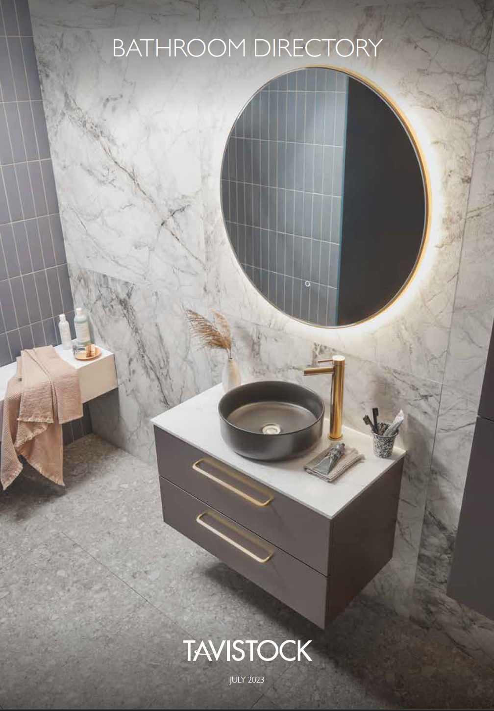 Modern bathroom vanity with round mirror, gray marble walls, and gold fixtures, Tavistock branding