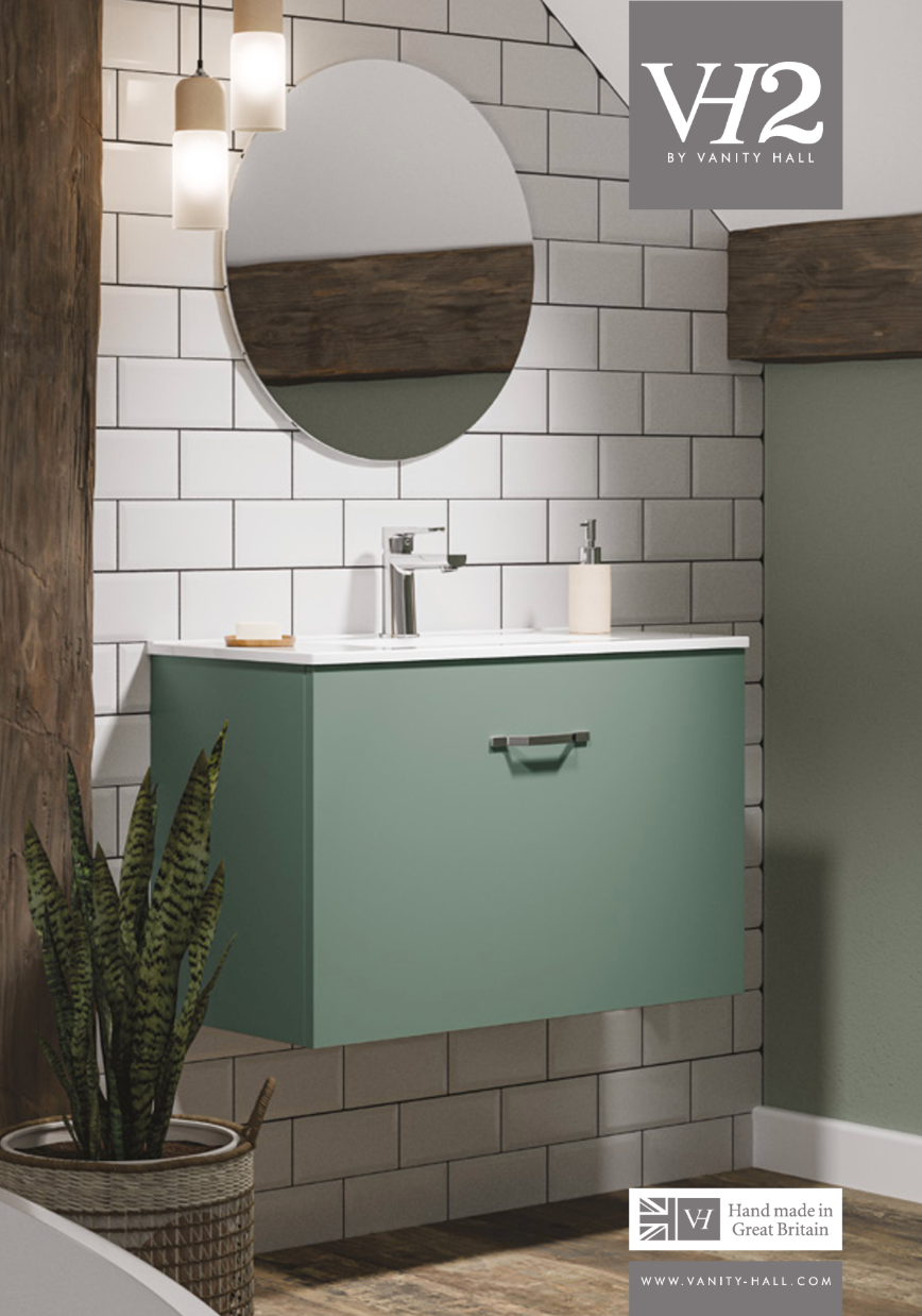 Mint green bathroom vanity with round mirror, white tile wall, and woven plant basket