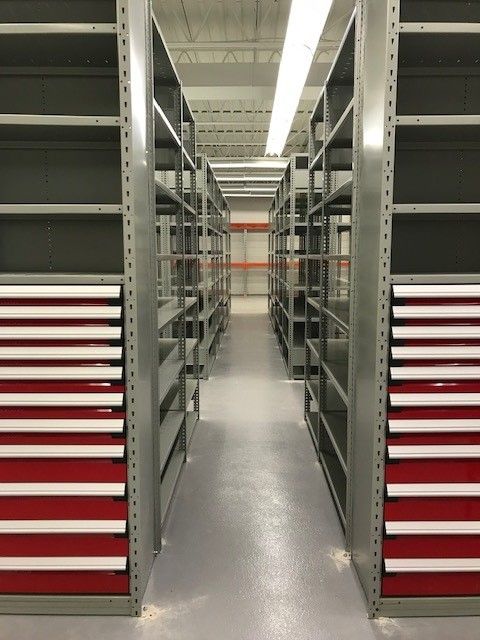 A row of shelves with red drawers between them
