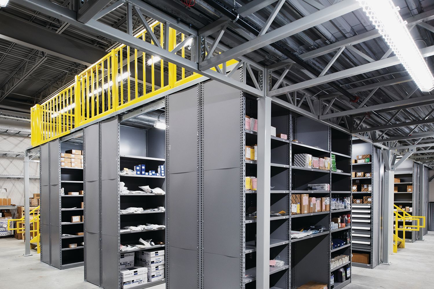 A warehouse with lots of shelves and a yellow railing.