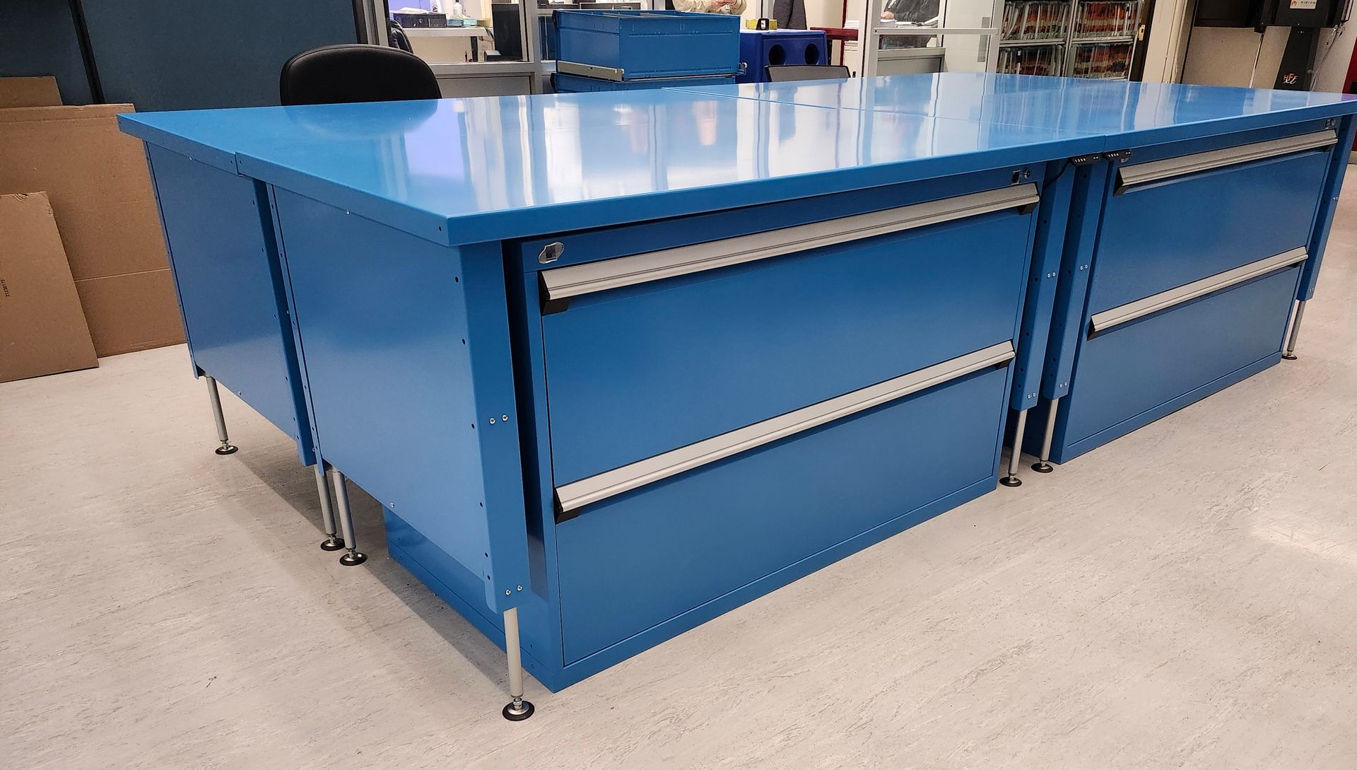 A blue table with drawers underneath it in a room