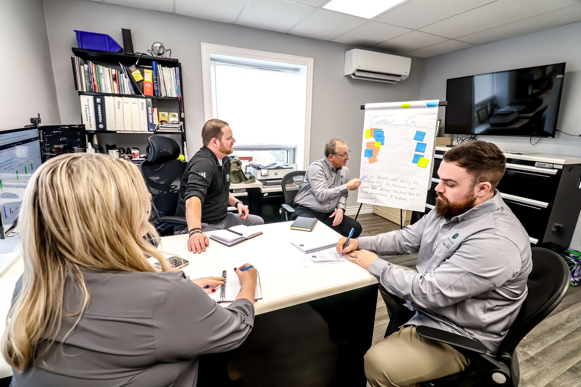 A group of people are sitting around a table in a conference room.